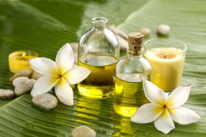 stones with yellow candle ,massage oil on wet banana leaf